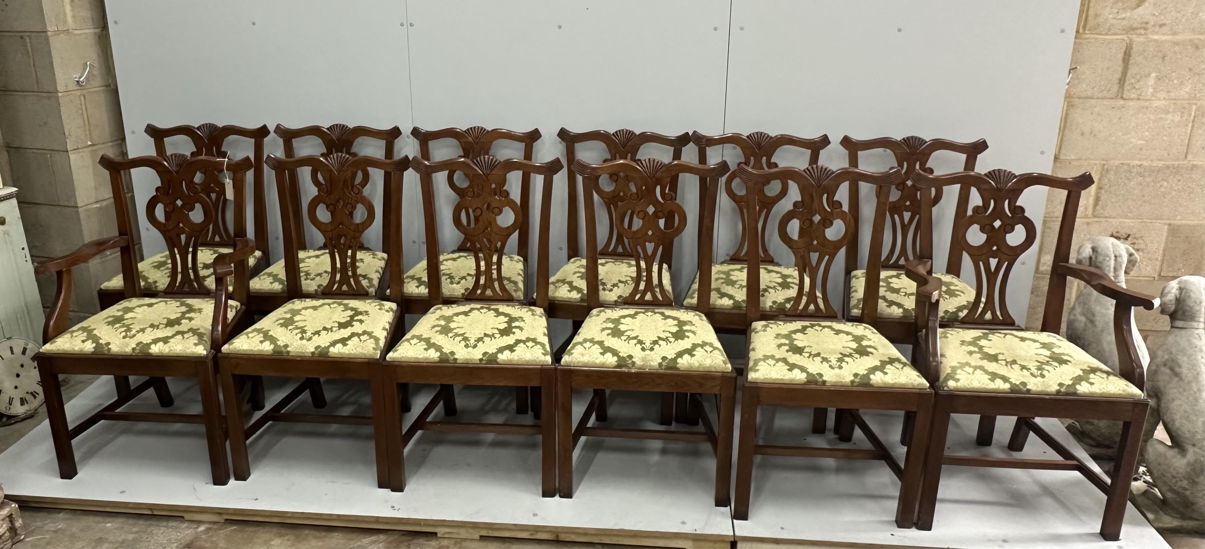 A set of twelve reproduction Chippendale style oak dining chairs, two with arms. Condition - good